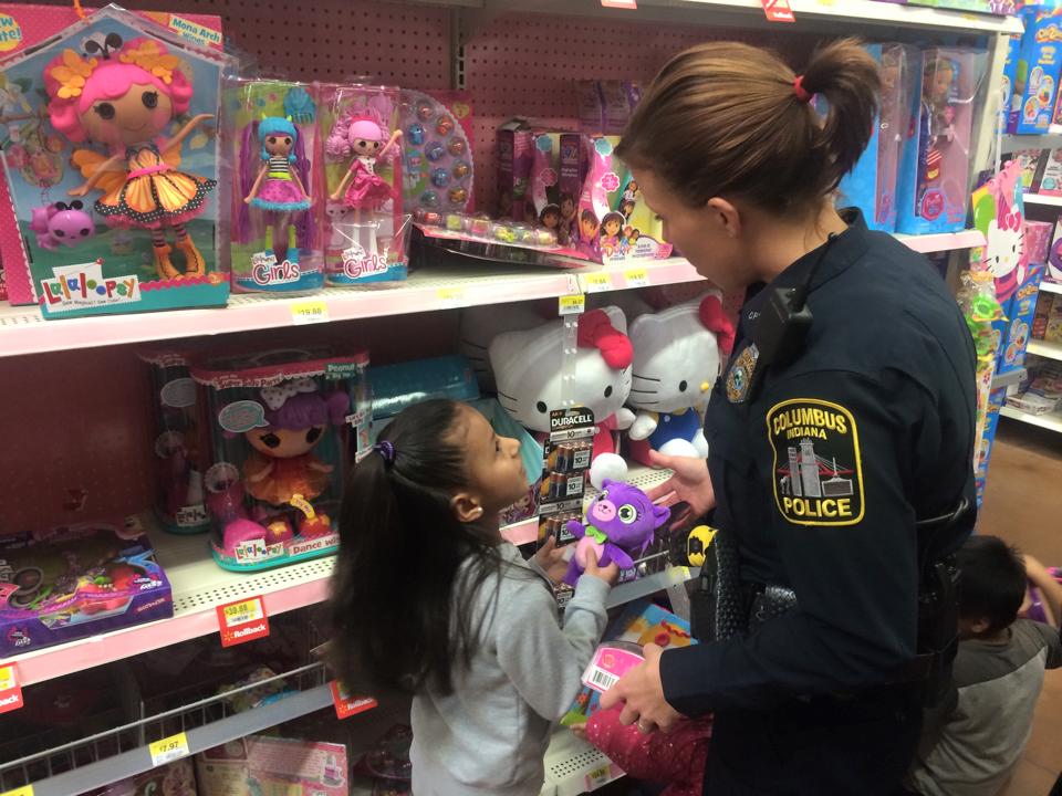 Police officer with child looking at toys.