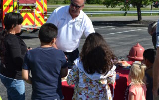 Children meeting firefighter at fire truck