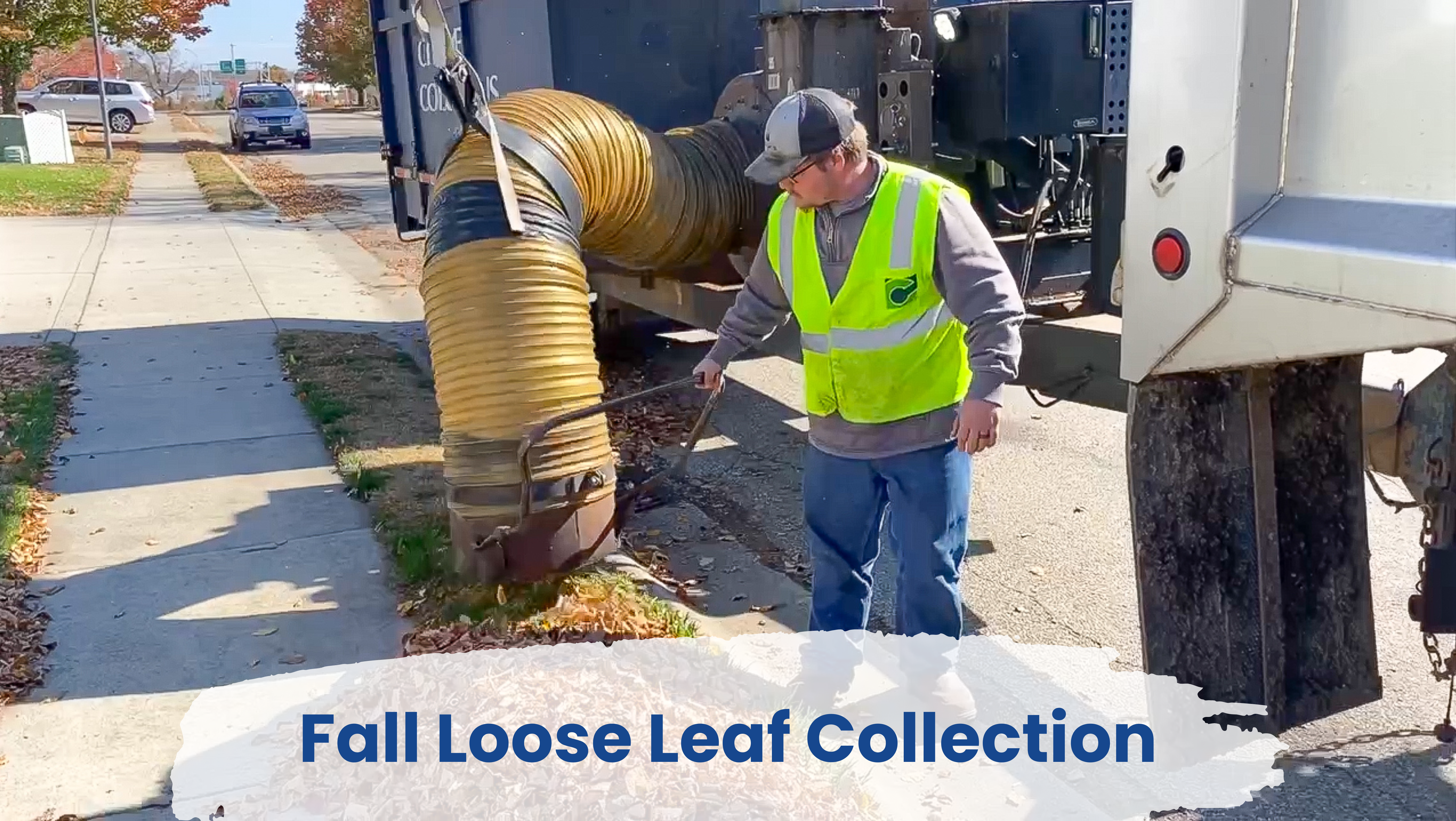 DPW worker collecting leaves with leaf vac