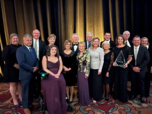 City officials pose with the Community of the Year award, November 16, 2022