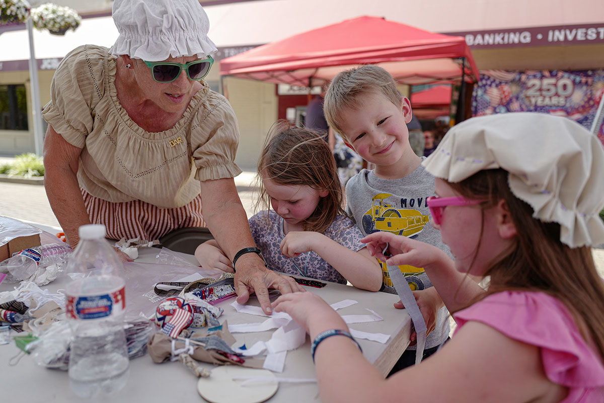 People take part in American Revolutino Day during Columbus's Celebrate 250's on Fourth Street in downtown Columbus, Indiana, Monday, June 29, 2026. Celebrate 250 is a six celebration marking America's 250th anniversary.