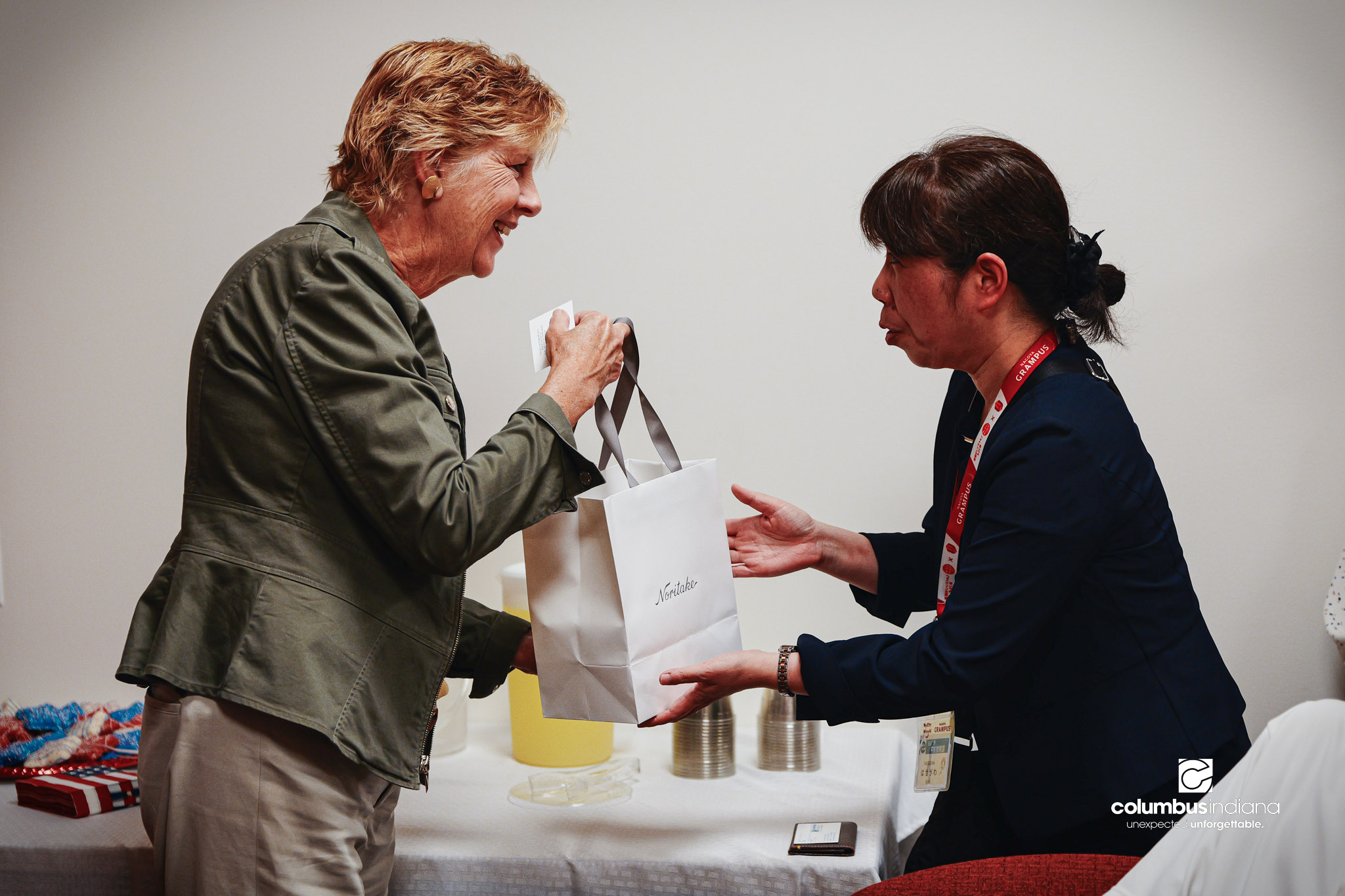 Columbus Mayor Mary Ferdon, left, accepts a gift from Yoko Hasegawa, with the Miyoshi City Board of Education, at Columbus City Hall in Columbus, Ind., Thursday, Aug. 20, 2026. A delegation of students and school officials from Miyoshi visited City H