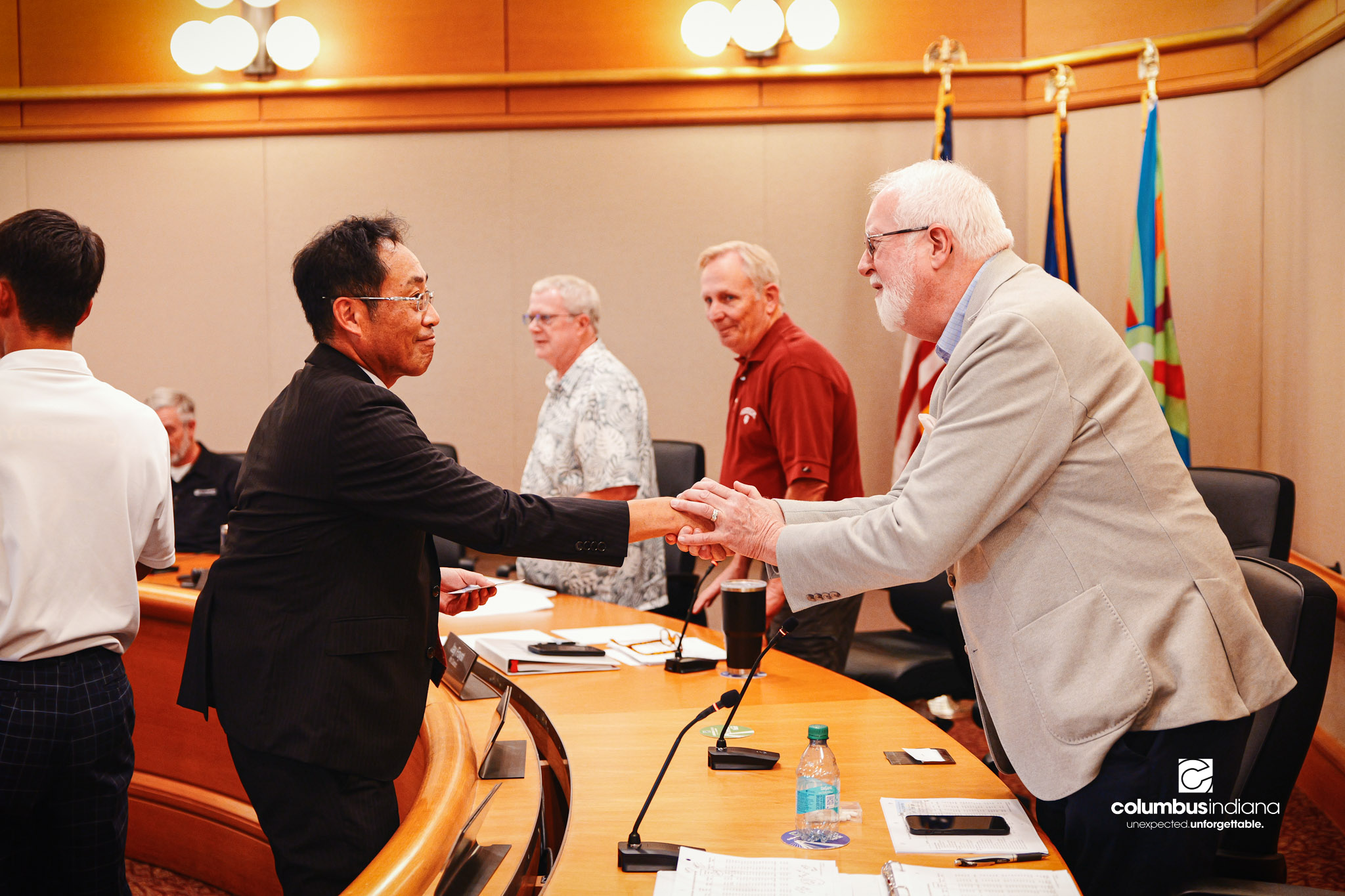 Miyoshi-Minami Junior High Principal Hioki Mutsuchika, left, shakes hands with Columbus City Council member Tom Dell during a tour of Columbus City Hall in Columbus, Ind., Thursday, Aug. 20, 2026. A delegation of students and school officials from Mi