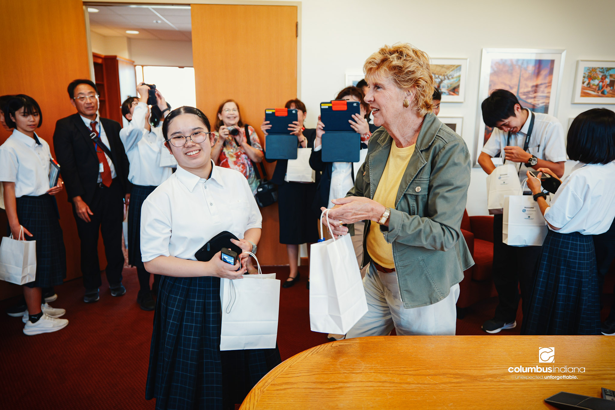 Columbus Mayor Mary Ferdon hands out gifts to a delegation of students and school officials from Miyoshi-Minami Junior High School on a tour of Columbus City Hall in Columbus, Ind., Thursday, Aug. 20, 2026. Miyoshi is Columbus’ sister city in Japan