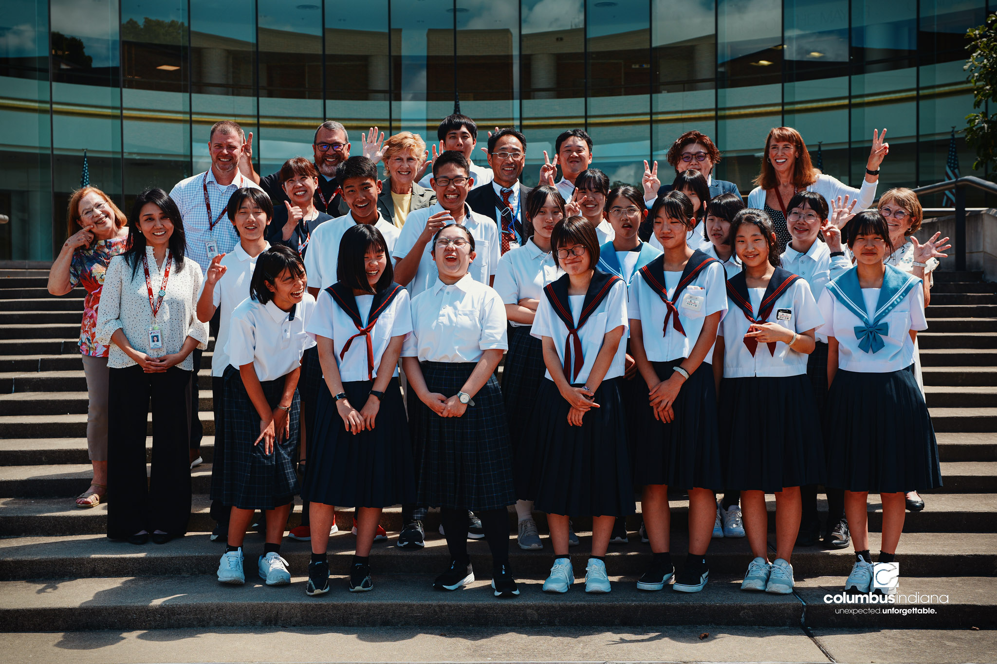 A delegation of students and school officials from Miyoshi-Minami Junior High School, the City of Columbus and Bartholomew Consolidated School Corp., pose for a photo on the steps of Columbus City Hall in Columbus, Ind., Thursday, Aug. 20, 2026. The