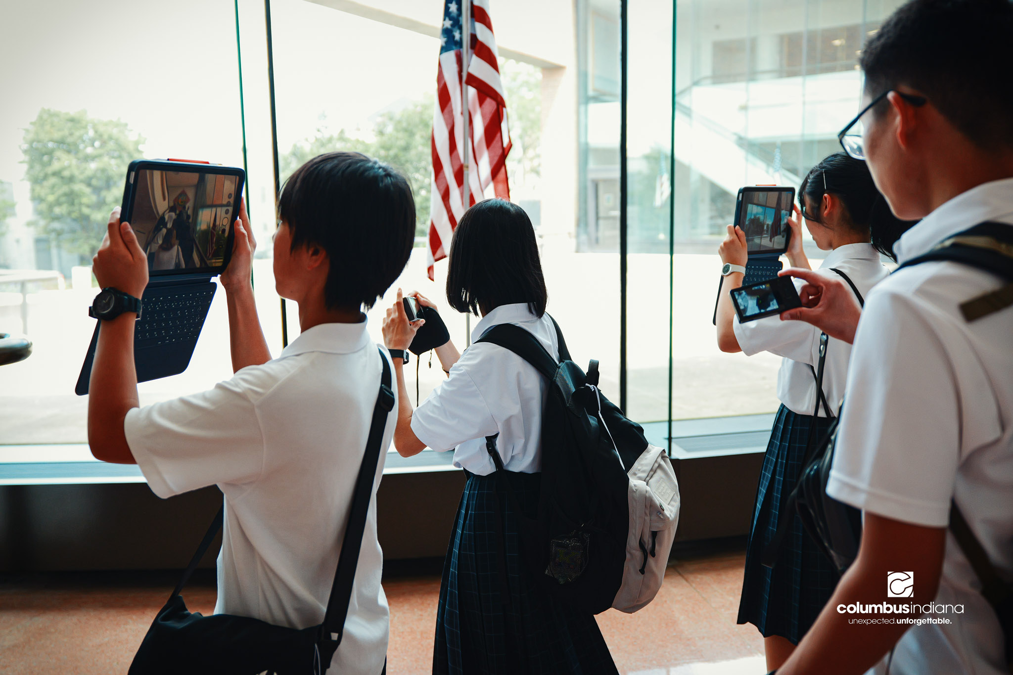 Students from Miyoshi-Minami Junior High School take photos of Columbus City Hall in Columbus, Ind., Thursday, Aug. 20, 2026. A delegation of students and school officials from Miyoshi visited City Hall for a tour of the building as part of their vis