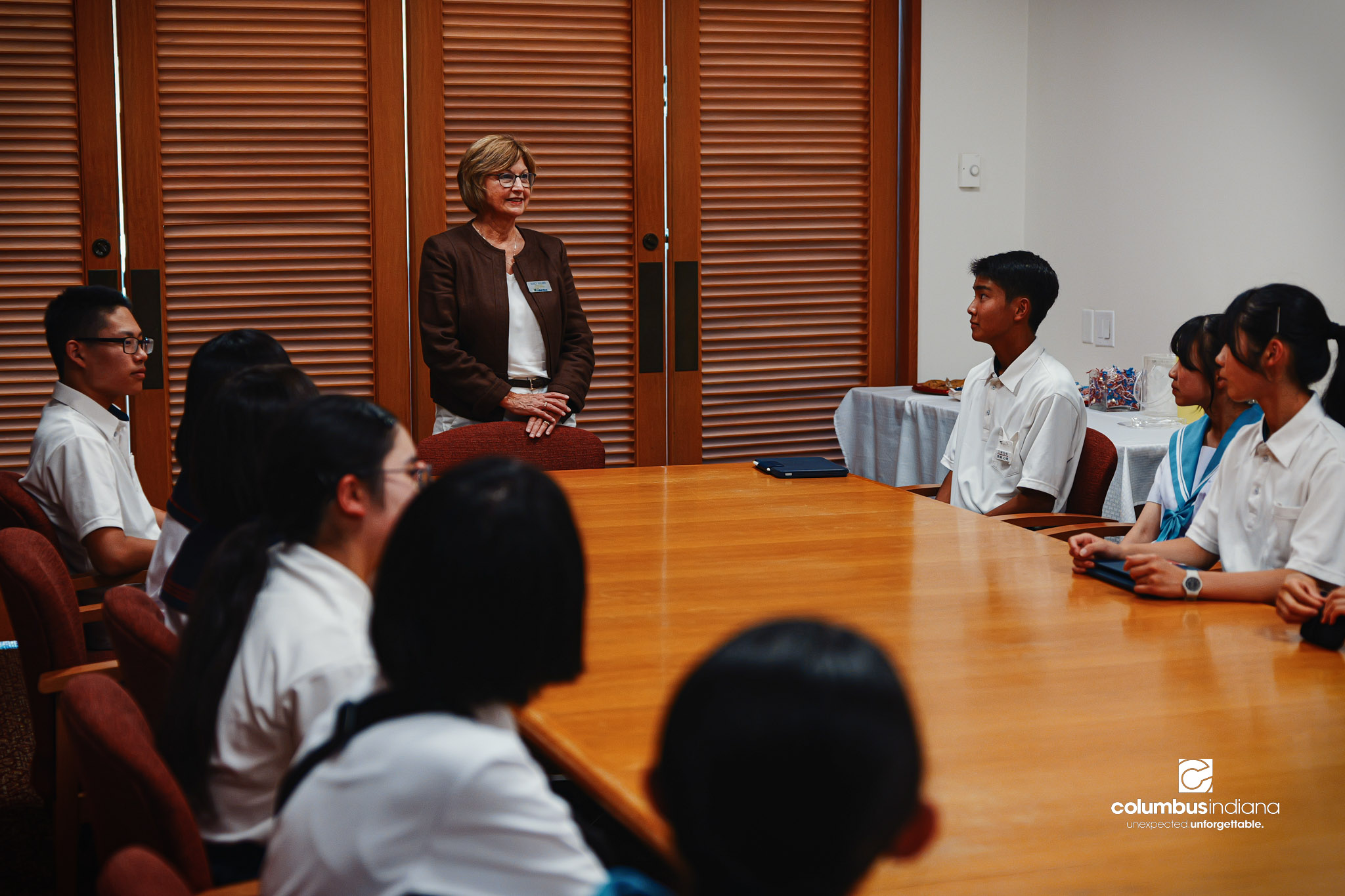Nancy Wagner, executive assistant to the mayor, address a delegation of students and school officials from Miyoshi-Minami Junior High School in a conference room at Columbus City Hall in Columbus, Ind., Thursday, Aug. 20, 2026. The delegation of stud