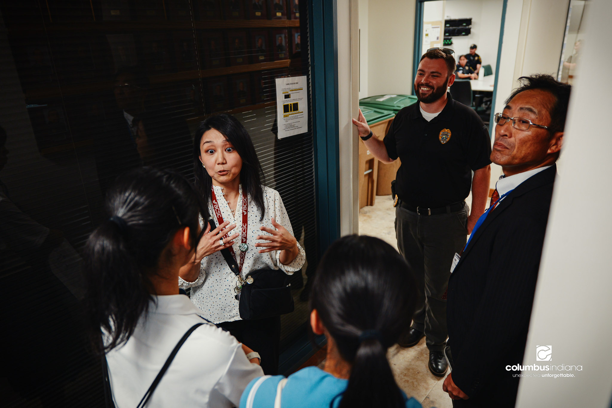 Maya Sutherland, left, with BCSC, translates as Columbus Police Lt. Skylar Berry guides a delegation of students and school officials from Miyoshi-Minami Junior High School on a tour of the Columbus Police Department in Columbus, Ind., Thursday, Aug.