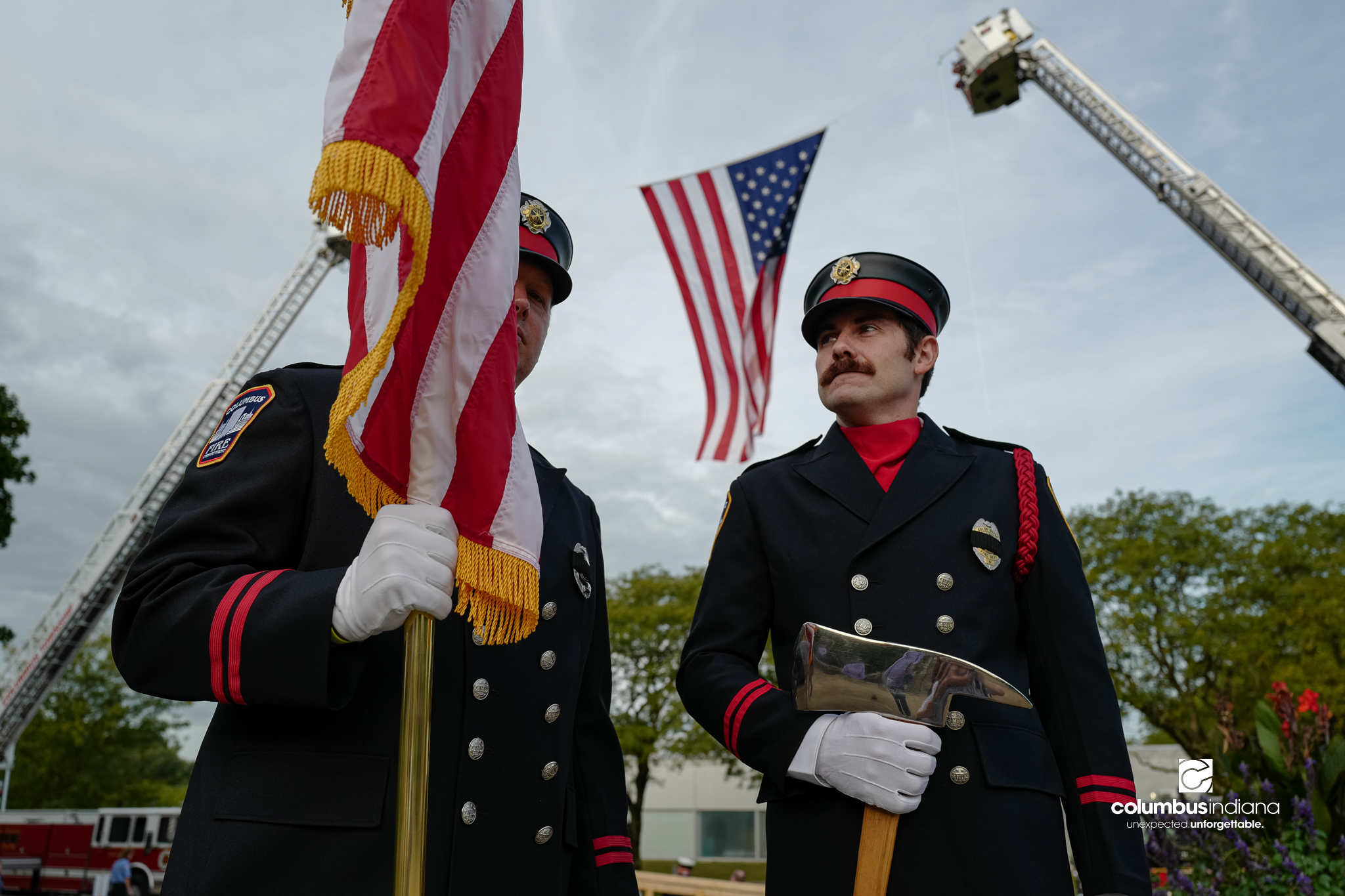 Columbus Fire Lt. Jarrad Mullis, left, and firefighter Brayden Warfield wait to take part in a ceremony to commemorate the 25th anniversary of Sept. 11, at Columbus City Hall in Columbus, Ind., Friday, Sept. 11, 2026.