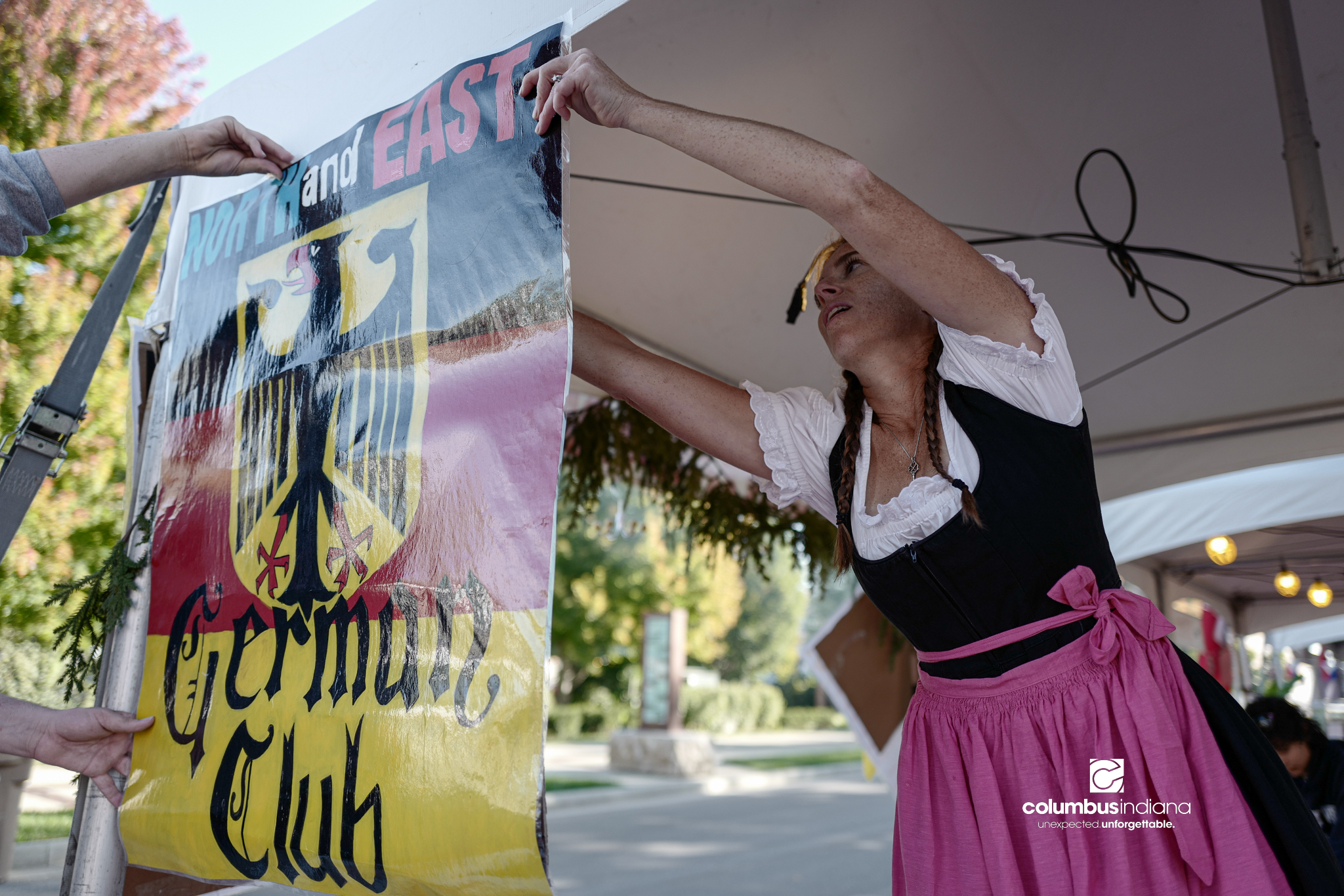 Various images of the sights of Ethnic Expo in Columbus, Indiana. The photos show food, people of different ethnicities and performances as well tents and other spaces vendors are using.