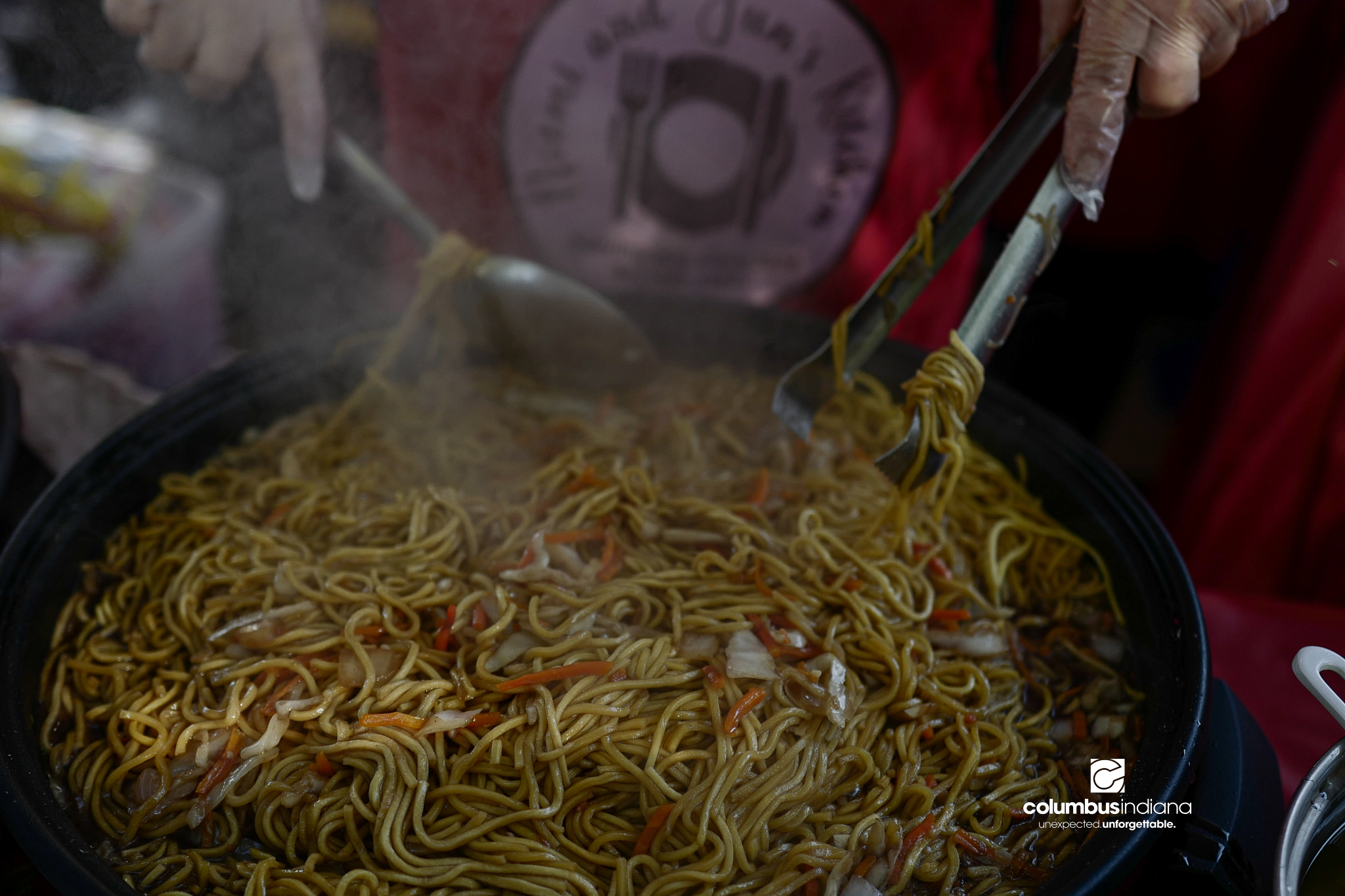 Various images of the sights of Ethnic Expo in Columbus, Indiana. The photos show food, people of different ethnicities and performances as well tents and other spaces vendors are using.