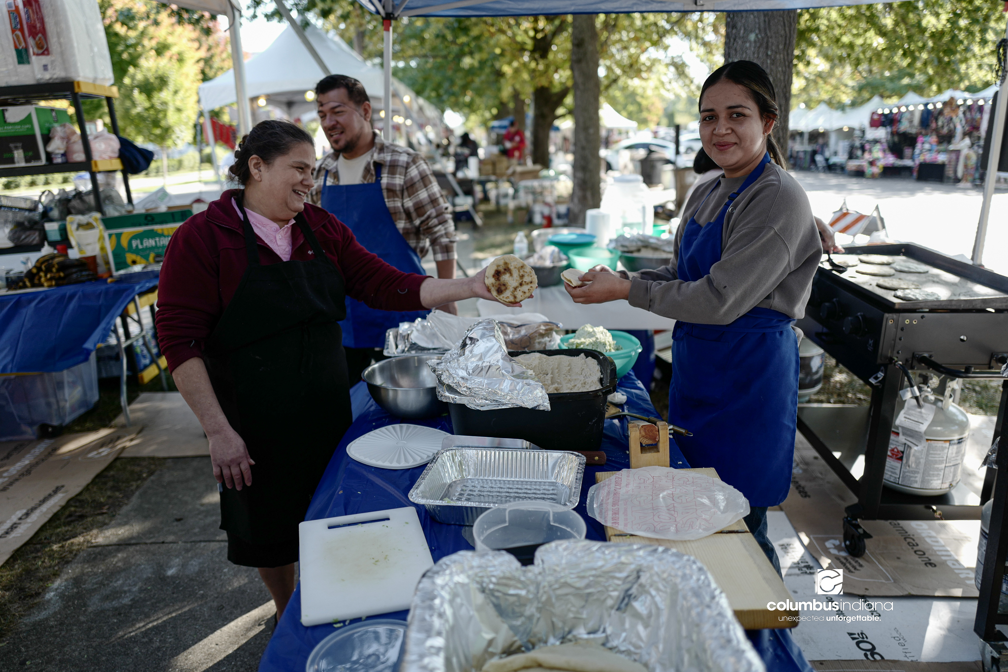 Various images of the sights of Ethnic Expo in Columbus, Indiana. The photos show food, people of different ethnicities and performances as well tents and other spaces vendors are using.