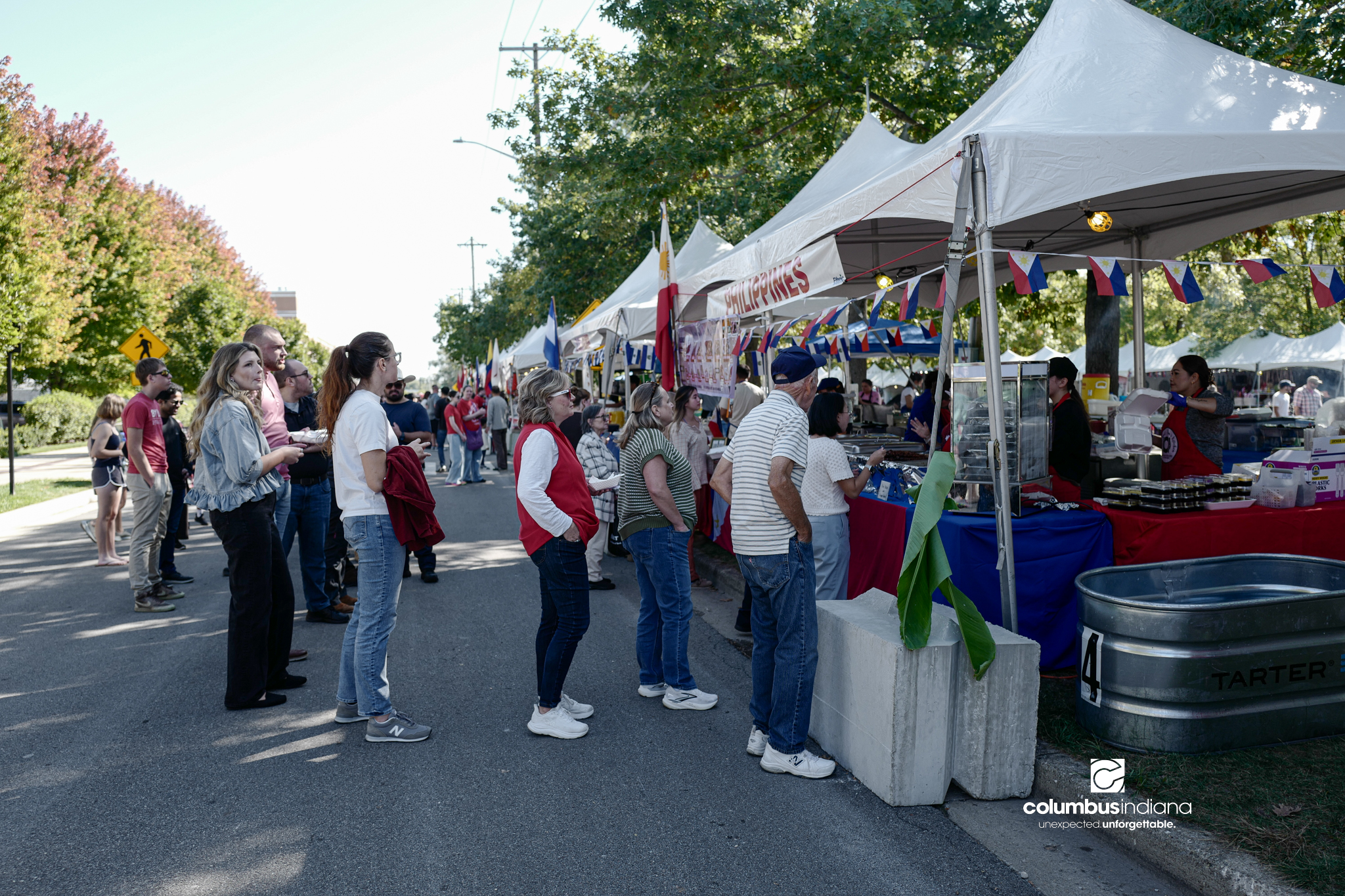 Various images of the sights of Ethnic Expo in Columbus, Indiana. The photos show food, people of different ethnicities and performances as well tents and other spaces vendors are using.
